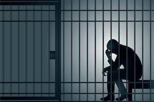 Sad man in jail cell
